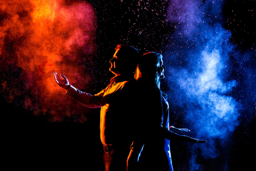 Couple taking creative engagement photos at night time with vibrant colors. Photography by Shannon Cain Photography