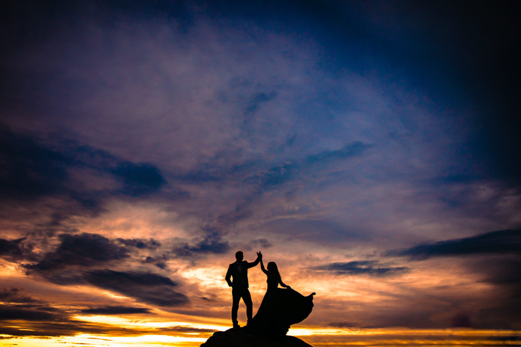 Couple twirling on a mountain top for engagement photos at sunset in Ruidoso, New Mexico.  Photo by Shannon Cain Photography