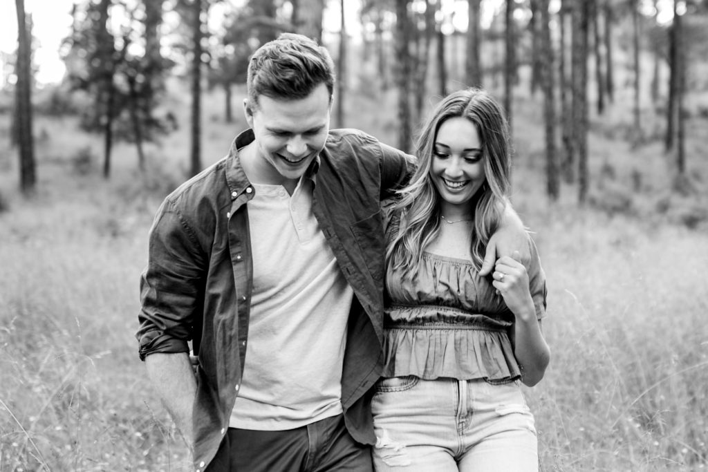 Engaged couple casually walk in the forest of Ruidoso, New Mexico for Engagement Photos. Photography by Shannon Cain Photography