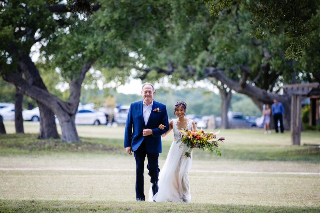 Father of the Bride walks bride down the aisle at Bergheim Ranch in Boerne.  Photo by Shannon Cain Photography