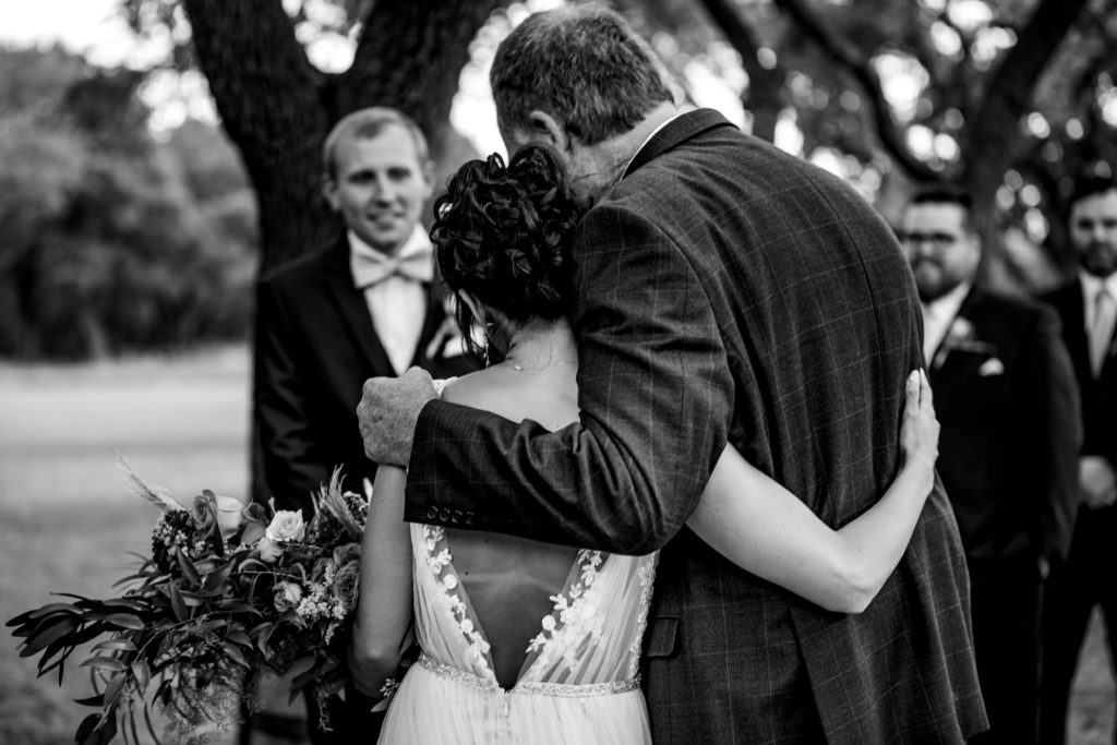Father and Bride hug before he hands his daughter over to the groom at Bergheim Ranch in Boerne.  Photo by Shannon Cain Photography