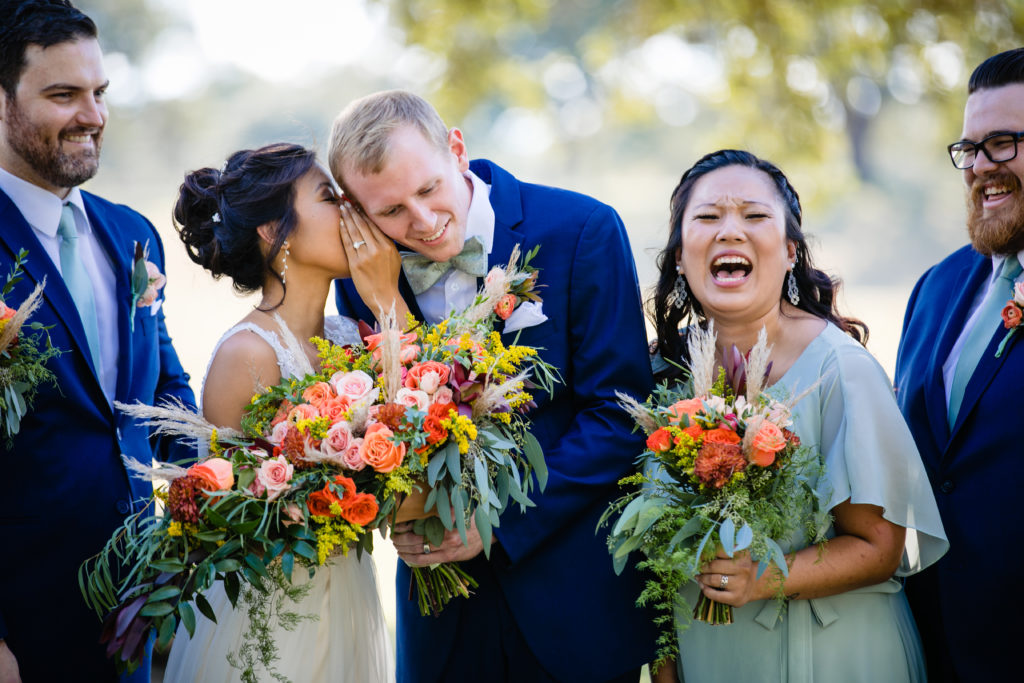 Bride whispers to groom during bridal party portraits at Bergheim Ranch in Boerne.  Photo by Shannon Cain Photography