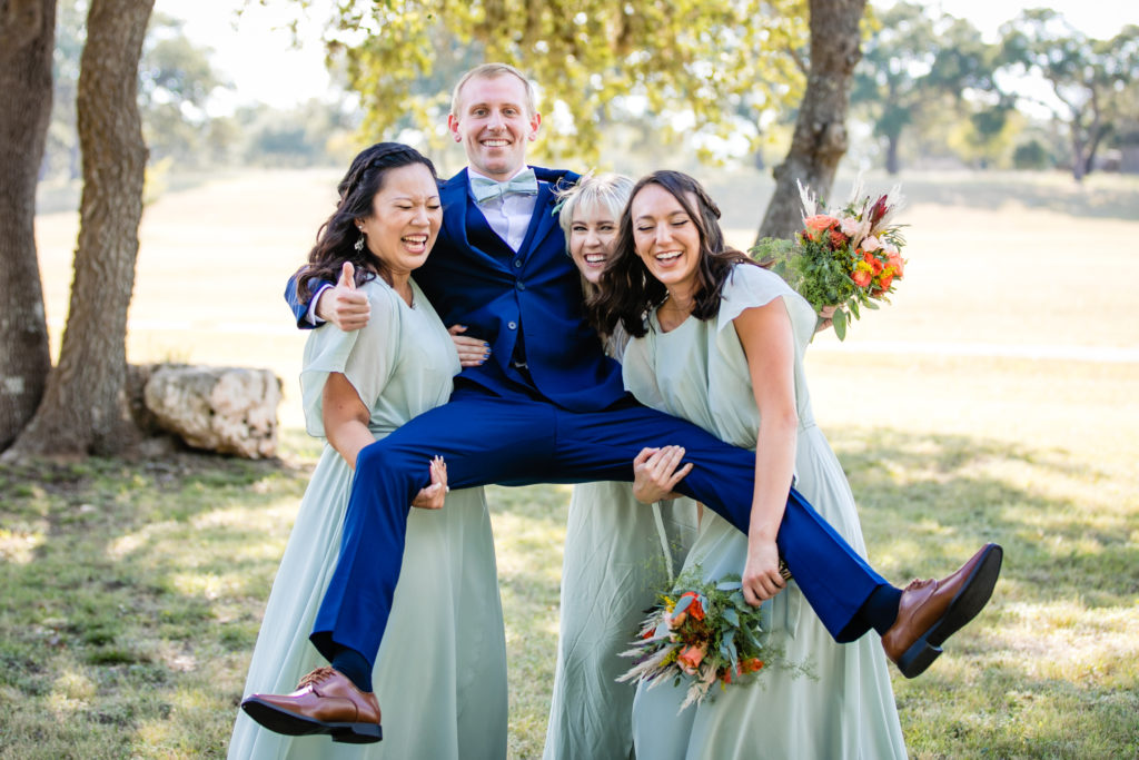Bridesmaids hold up groom at Bergheim Ranch in Boerne.  Photo by Shannon Cain Photography
