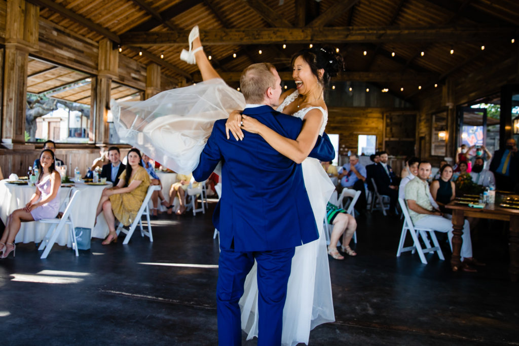 Groom lifts bride during first dance at Bergheim Ranch in Boerne.  Photo by Shannon Cain Photography