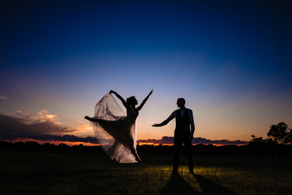 Bride leaps to groom during sunset portraits at Bergheim Ranch in Boerne.  Photo by Shannon Cain Photography