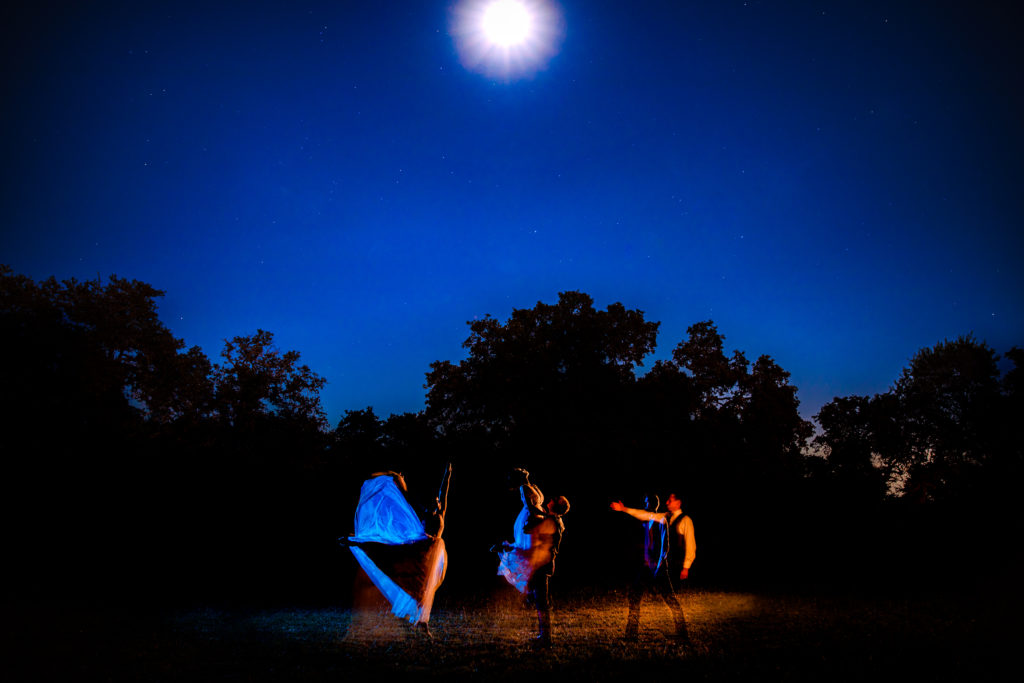 Bride leaps to groom under a full moon at Bergheim Ranch in Boerne.  Photo by Shannon Cain Photography