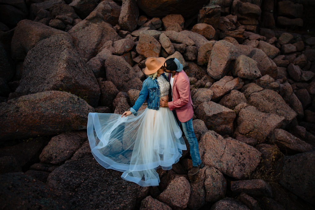 Bride and groom kiss in boulders for engagement session at Enchanted Rock State Park.  Photography by Shannon Cain Photography