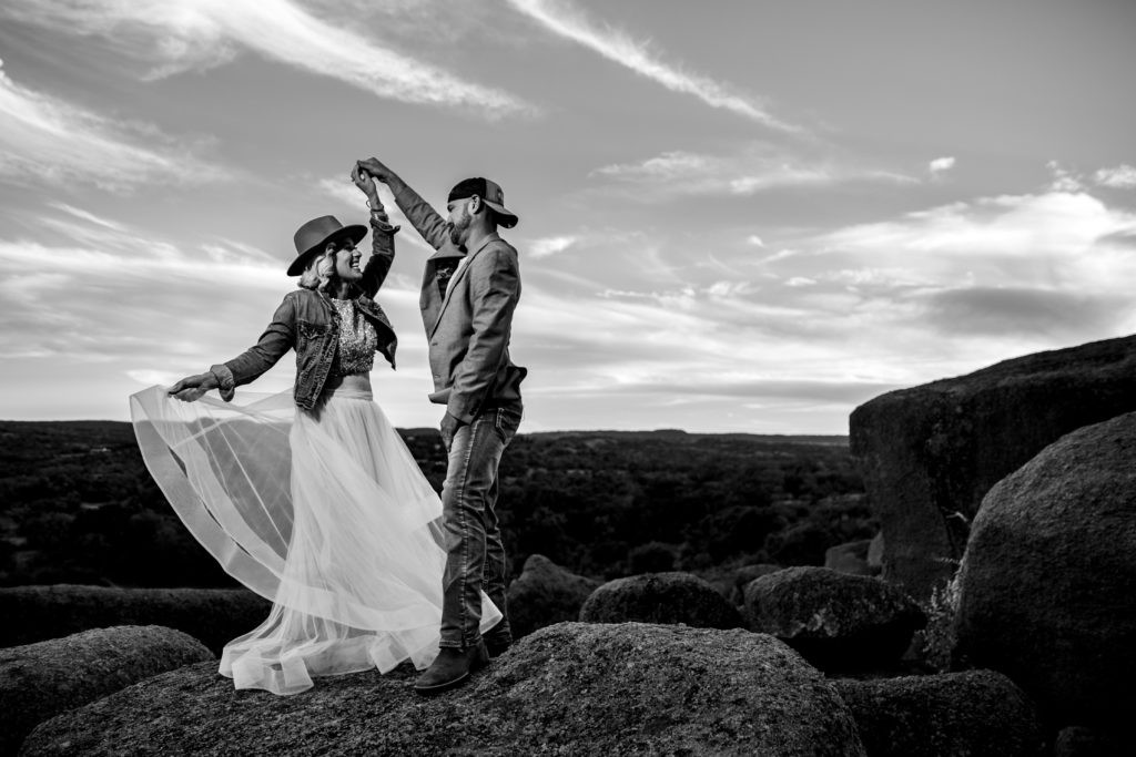 Bride and groom twirl at Enchanted Rock State Park.  Photography by Shannon Cain Photography