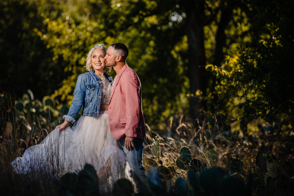 Groom kisses bride at Enchanted Rock State Park.  Photography by Shannon Cain Photography