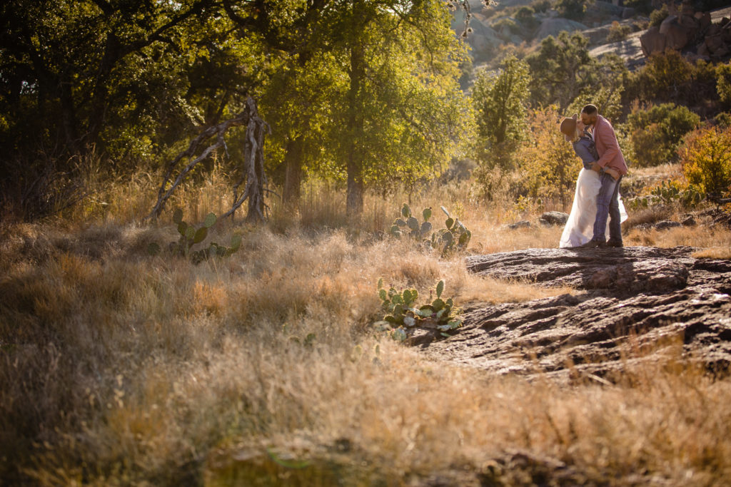 Groom dips bride at Enchanted Rock State Park.  Photography by Shannon Cain Photography