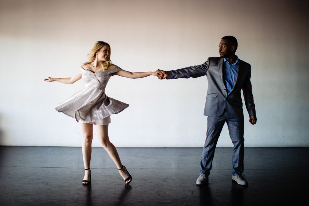 Dancing couple take engagement photos in studio setting. Photography by Shannon Cain Photography