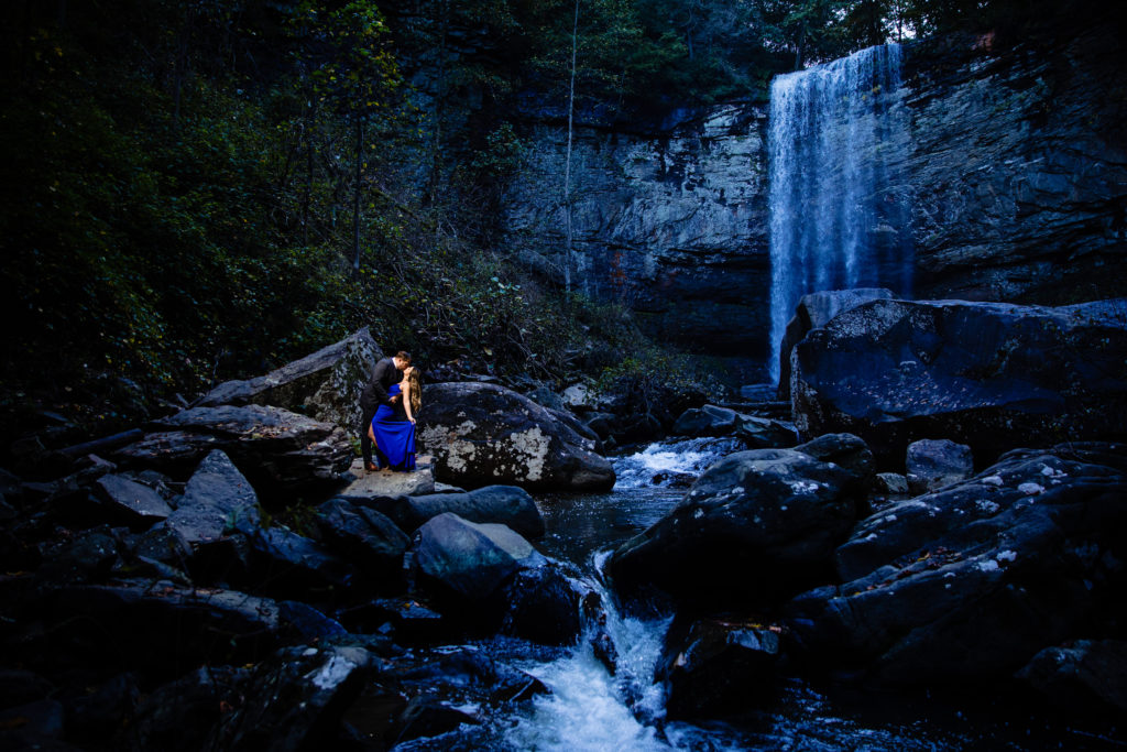 Adventure Engagement Session at Cloudland Canyon State Park in Georgia.  Couple standing under waterfall.  Photography by Shannon Cain Photography
