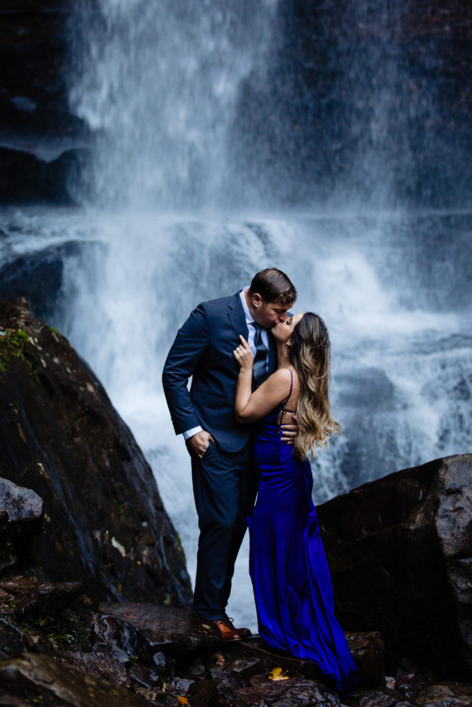 Adventure Engagement Session at Cloudland Canyon State Park in Georgia.  Couple standing under waterfall.  Photography by Shannon Cain Photography