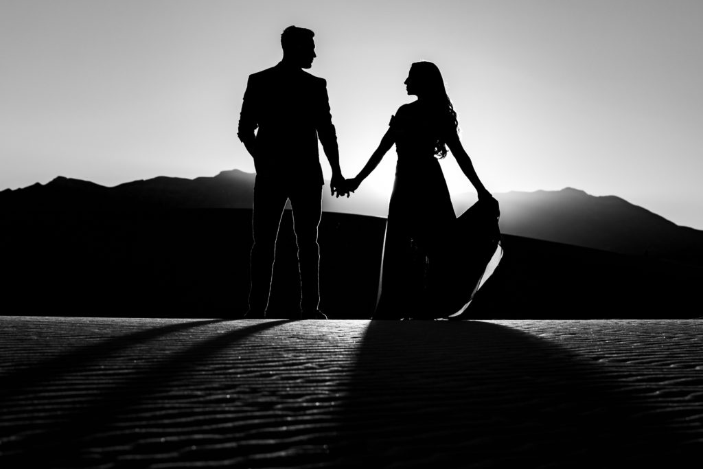 Bride and Groom holding hands at The White Sands National Park at sunset for Adventure Engagement Session.  Photography by Shannon Cain Photography.  Hair and Makeup by Glam on Demand.