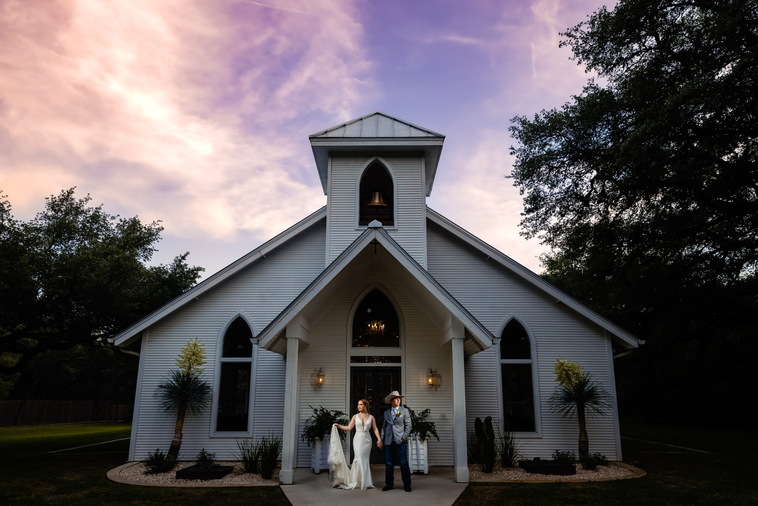 Bride and Groom get married in the little white chapel at The Chandelier of Gruene at sunset.